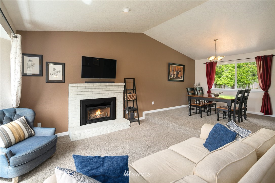 2329 169th Place Southeast Bothell, WA 98012 - Photo 2 of 18 a living room with furniture a large window and a fireplace