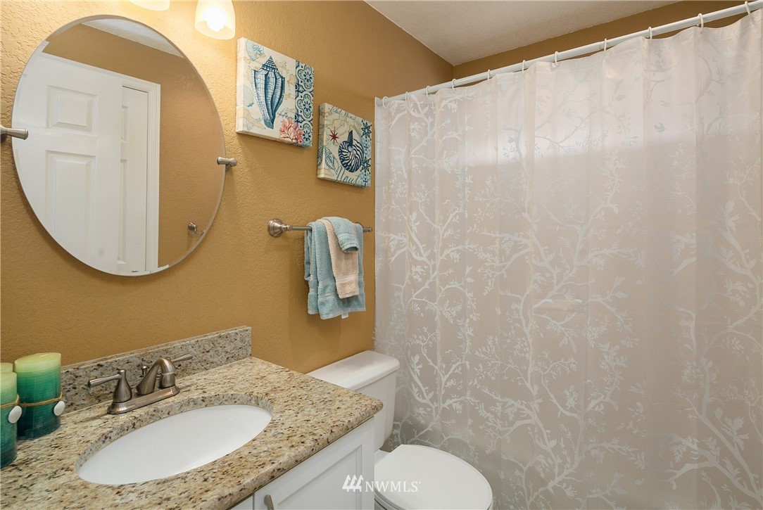 2329 169th Place Southeast Bothell, WA 98012 - Photo 12 of 18 a bathroom with a granite countertop sink and a mirror