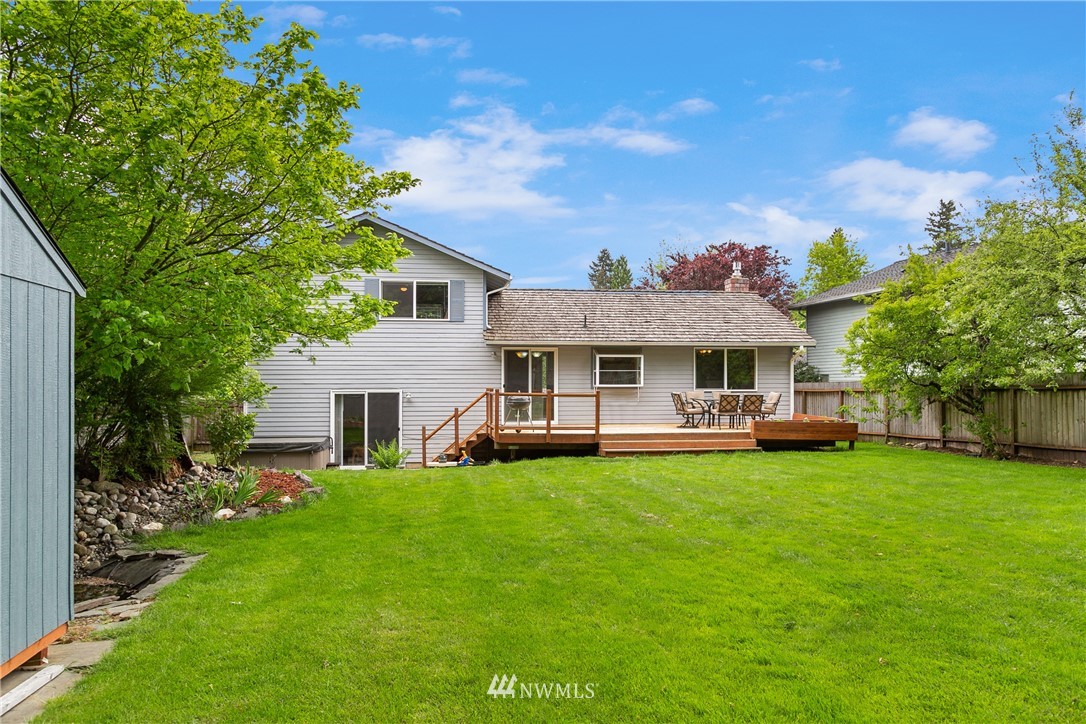 2329 169th Place Southeast Bothell, WA 98012 - Photo 16 of 18 a front view of a house with a garden and trees