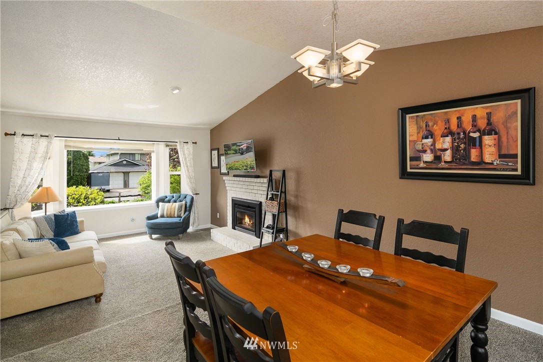 2329 169th Place Southeast Bothell, WA 98012 - Photo 5 of 18 a living room with furniture a chandelier and a table