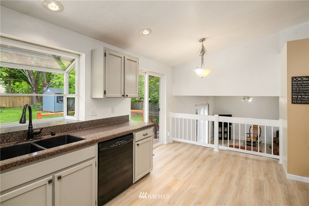 2329 169th Place Southeast Bothell, WA 98012 - Photo 6 of 18 a kitchen that has a lot of cabinets in it and wooden floors