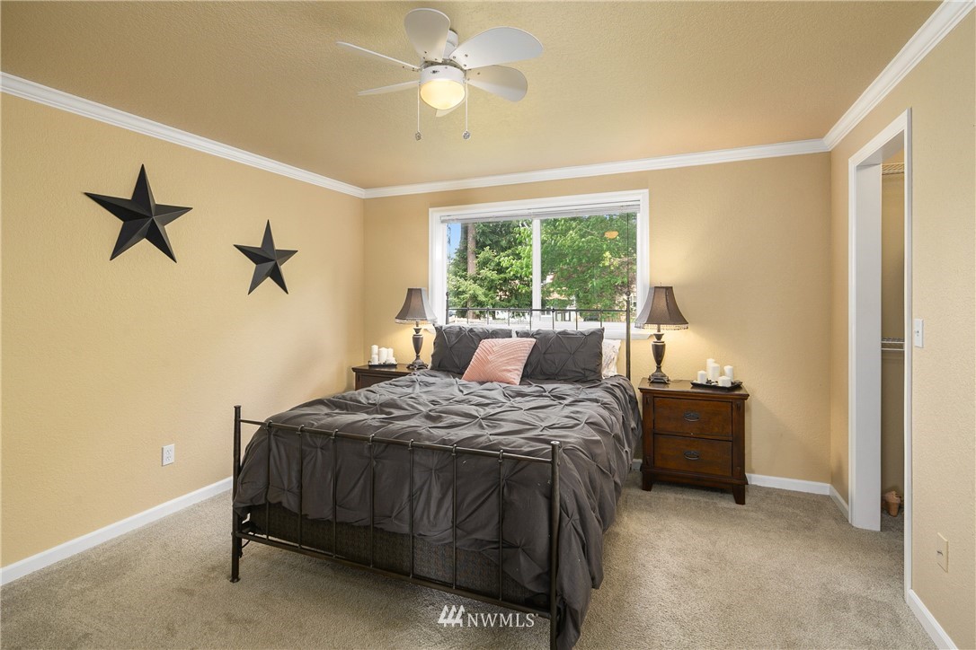 2329 169th Place Southeast Bothell, WA 98012 - Photo 8 of 18 a bedroom with a bed and a chandelier