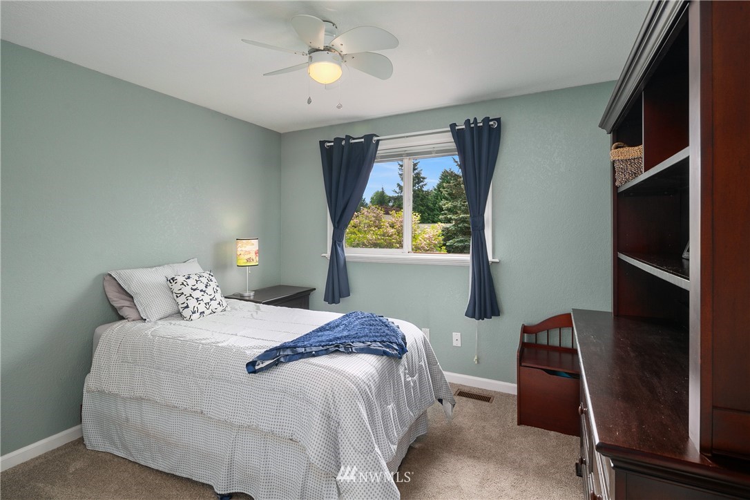 2329 169th Place Southeast Bothell, WA 98012 - Photo 10 of 18 a bedroom with a bed and a window
