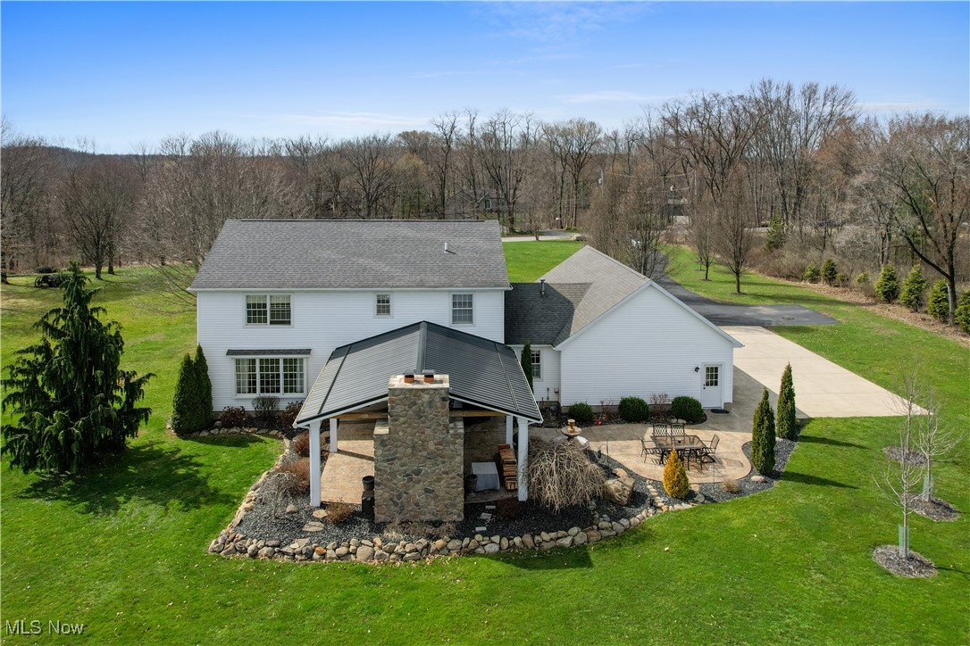 7285 South Raccoon Road Canfield, OH 44406 - Photo 42 of 46 Back of property with a patio area, a lawn, and a wooded view
