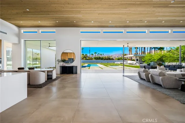 a kitchen with stainless steel appliances a sink a stove a table and chairs