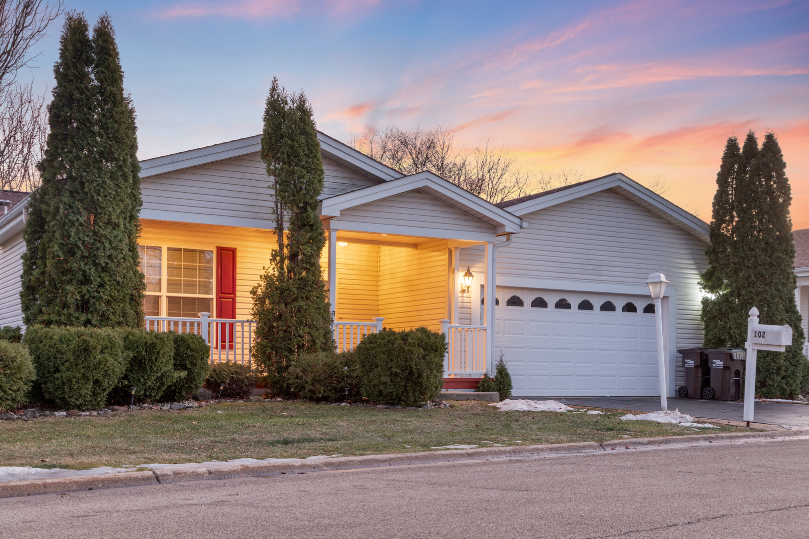 a view of a house with a yard and garage