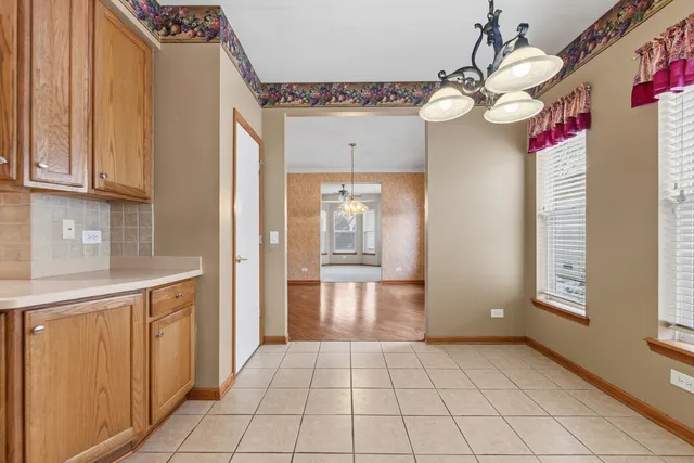 a kitchen with stainless steel appliances granite countertop a sink counter space cabinets and a large window