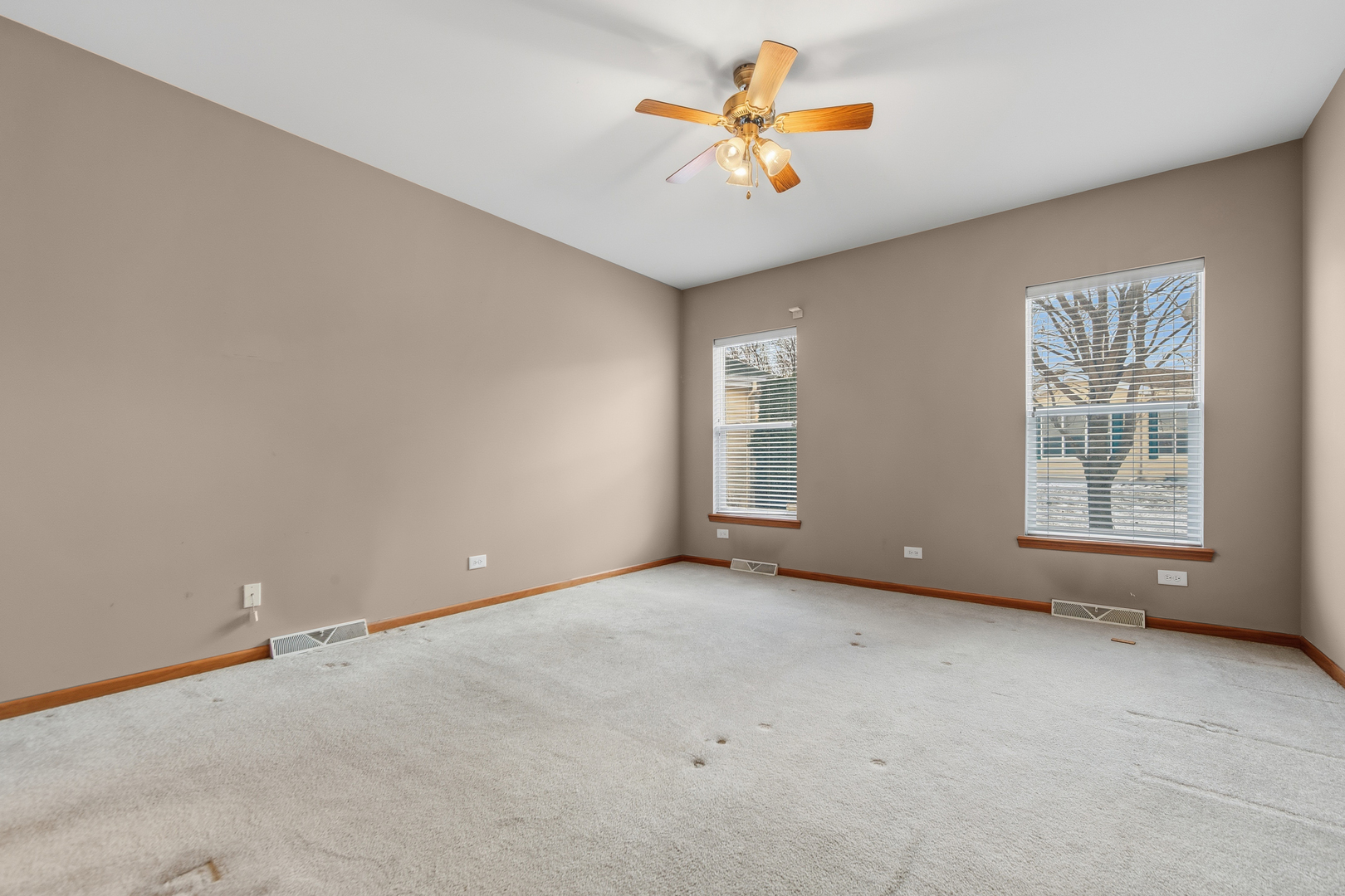 102 Hitching Post Lane Grayslake, IL 60030 - Photo 56 of 64 an empty room with windows and chandelier fan