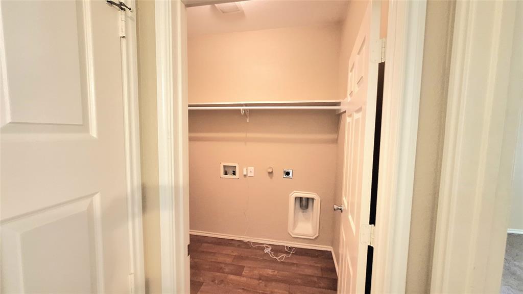 953 Hannah Way Dallas, TX 75253 - Photo 20 of 22 Dedicated laundry area featuring a wall-mounted shelf, utility hookups, and wood-finish flooring