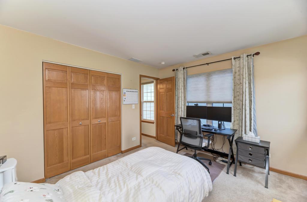 1846 Keystone Place Schaumburg, IL 60193 - Photo 22 of 30 a bedroom with a bed table chair and a window