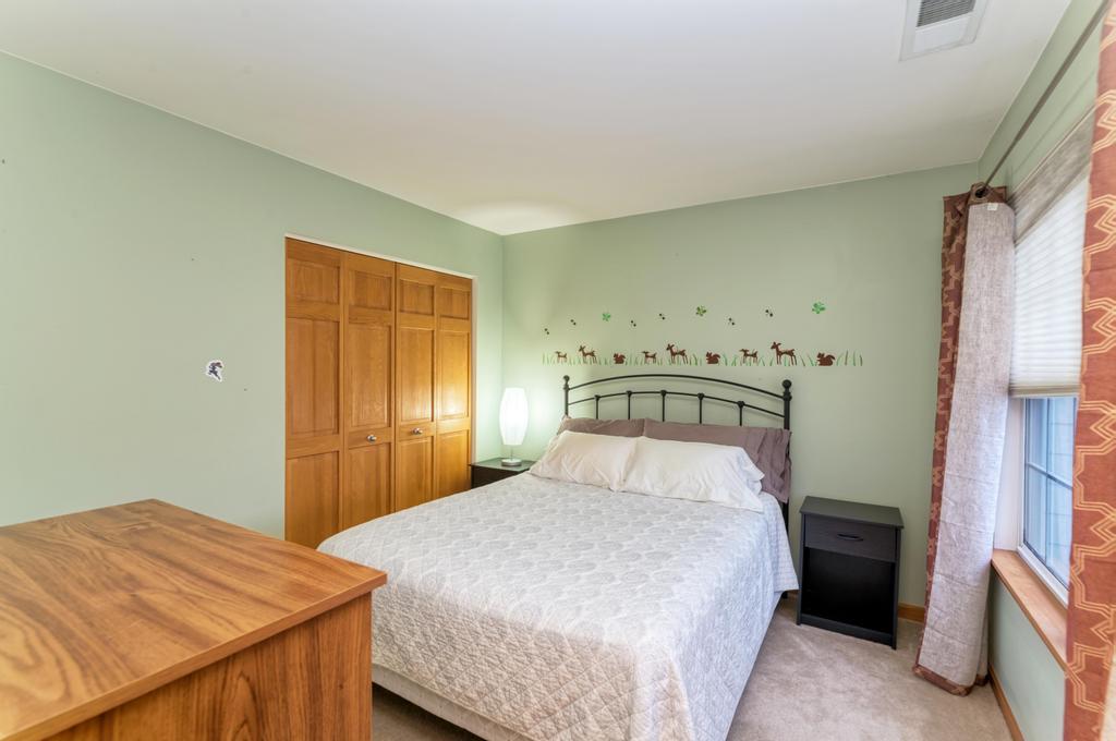 1846 Keystone Place Schaumburg, IL 60193 - Photo 23 of 30 a bedroom with a bed and a dresser