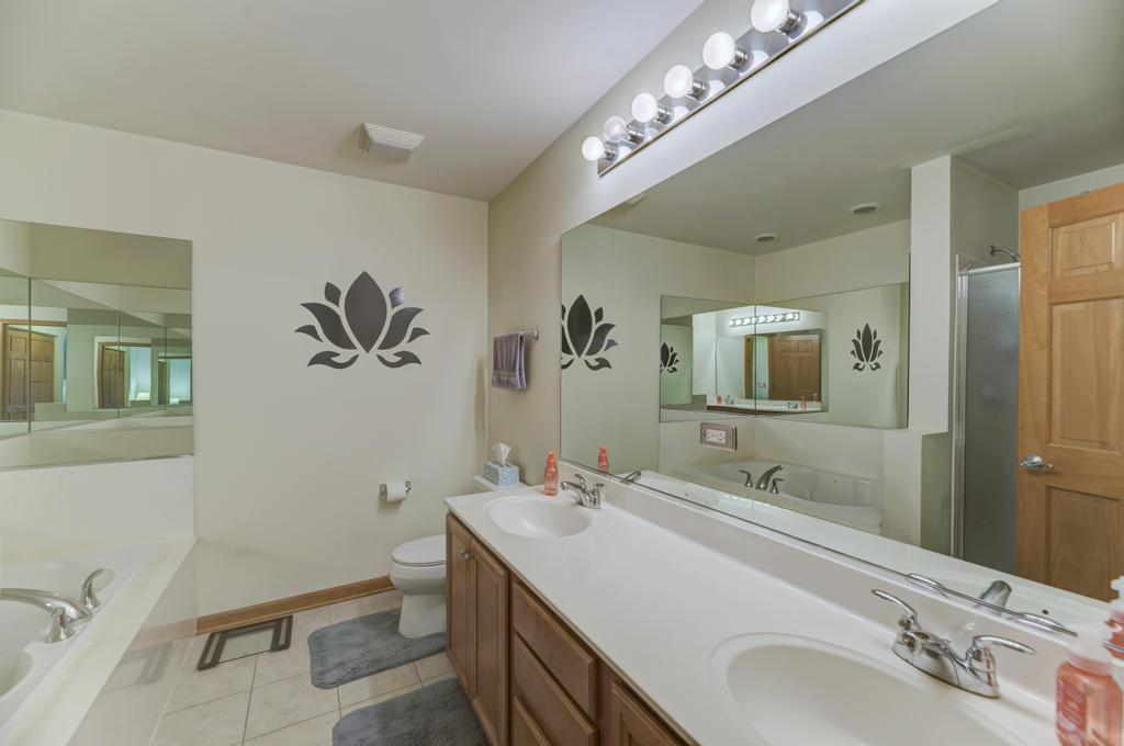 1846 Keystone Place Schaumburg, IL 60193 - Photo 25 of 30 a bathroom with a double vanity sink mirror and toilet