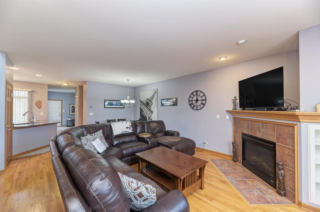 1846 Keystone Place Schaumburg, IL 60193 - Photo 5 of 30 a living room with furniture a flat screen tv and a fireplace