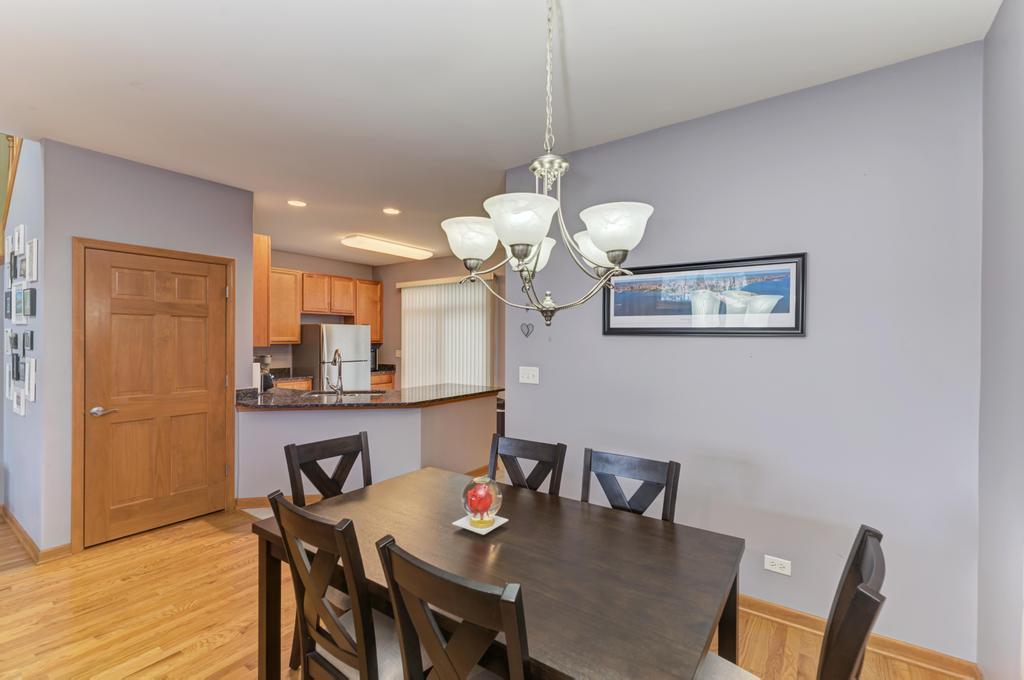 1846 Keystone Place Schaumburg, IL 60193 - Photo 8 of 30 a view of a dining room with furniture and wooden floor