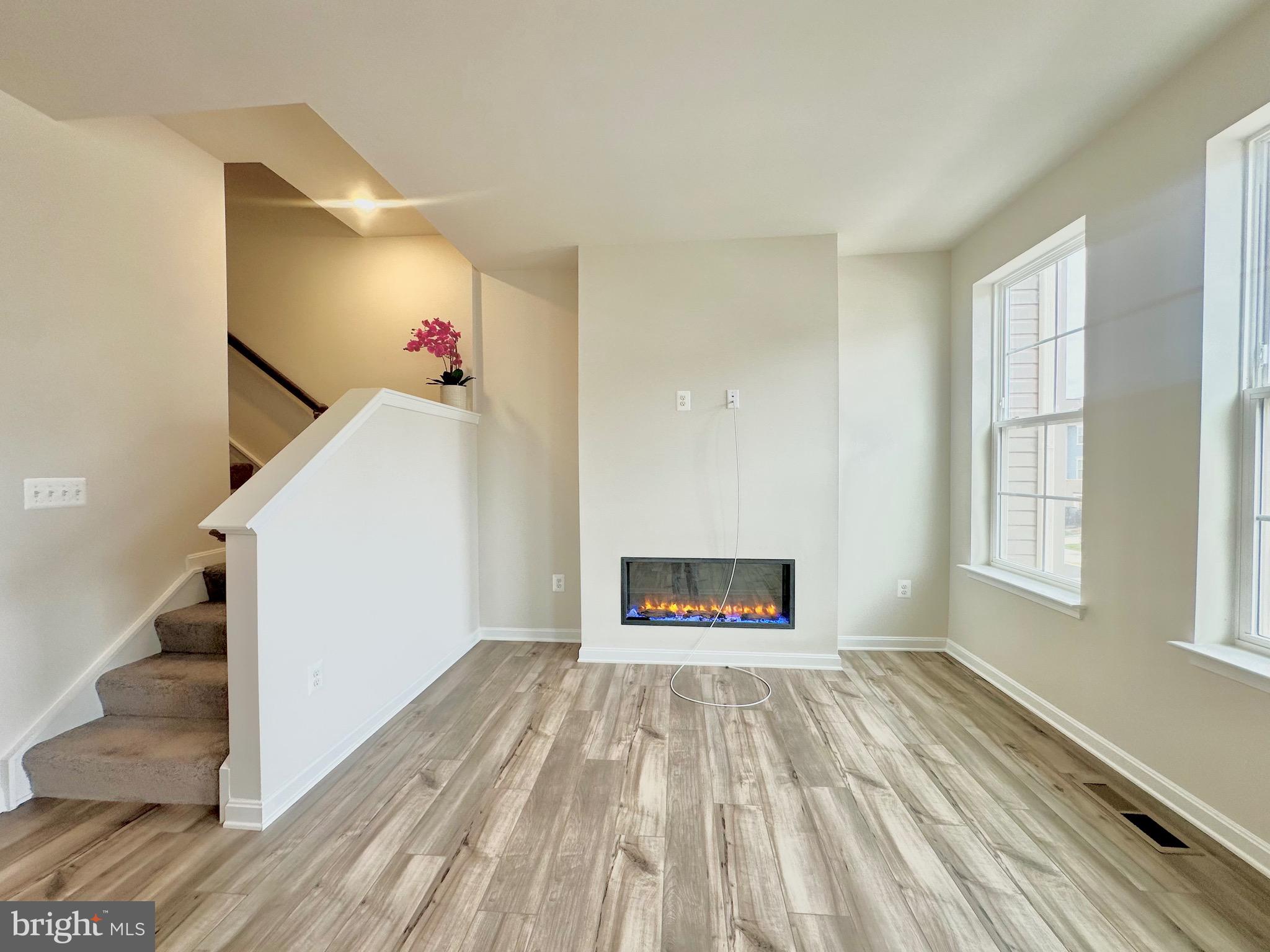 153 Telluride Way Charles Town, WV 25414 - Photo 3 of 21 a view of empty room with wooden floor and fan