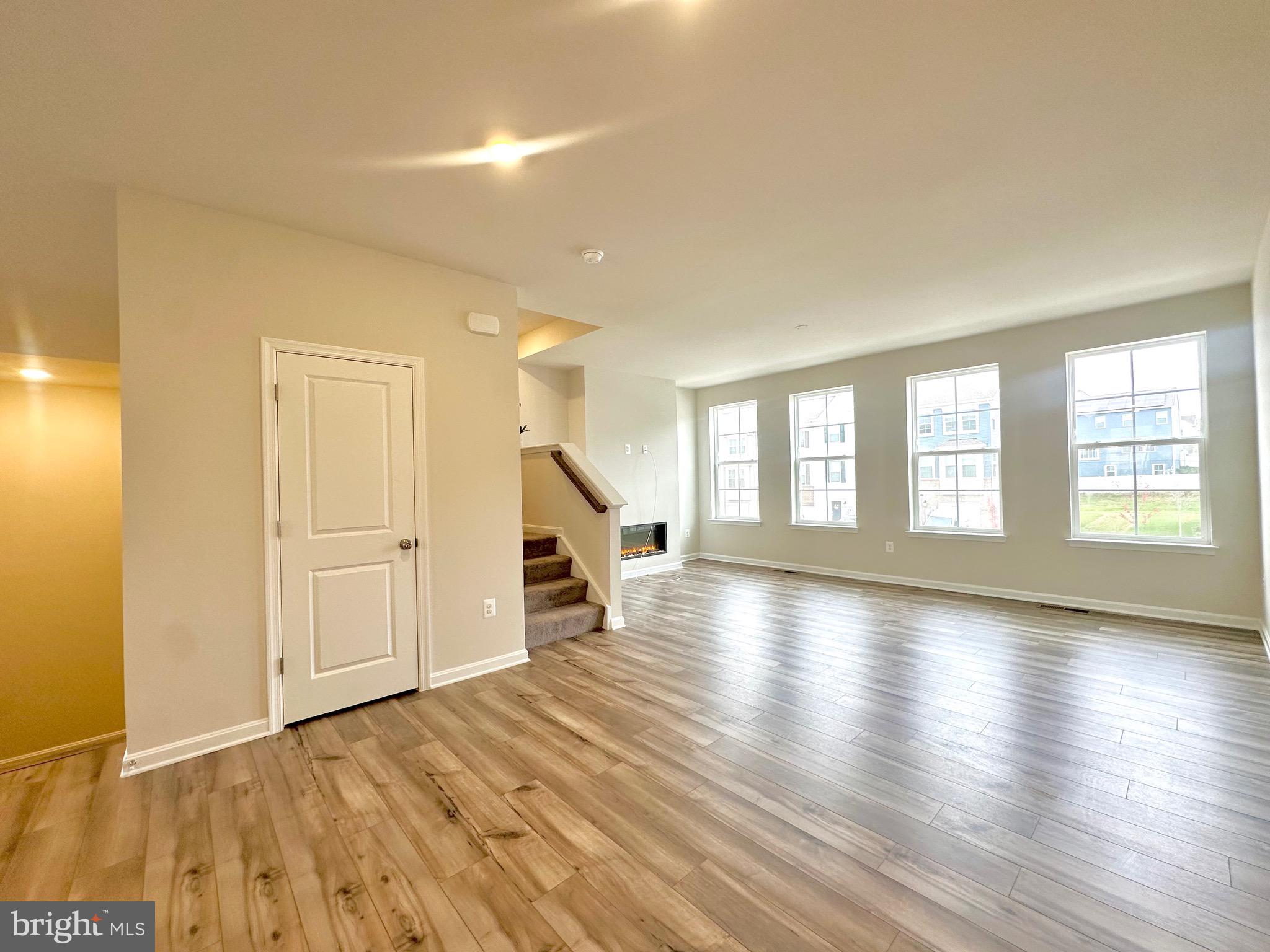 153 Telluride Way Charles Town, WV 25414 - Photo 4 of 21 a view of an empty room with wooden floor and a window