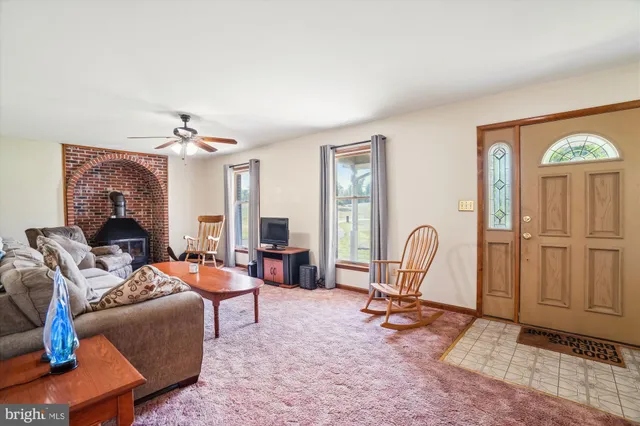 a living room with furniture a large window and rug