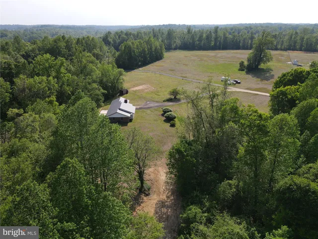 an aerial view of a house with a yard