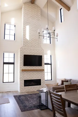 a living room with furniture a fireplace and windows