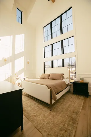a spacious bedroom with a bed and a window
