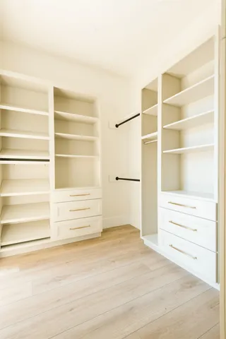a view of walk in closet and empty room