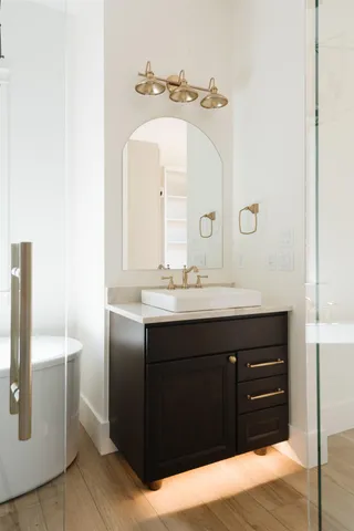 a bathroom with a sink vanity and a mirror