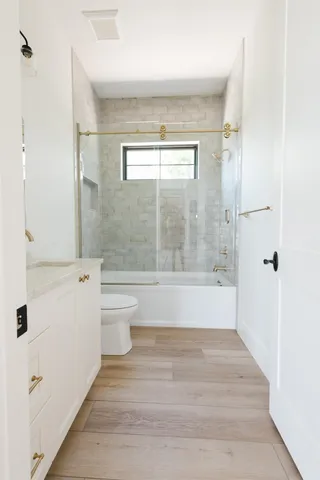 a bathroom with a shower and a toilet