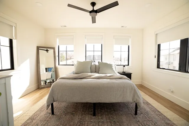 a spacious bathroom with a bathtub shower sink mirror and toilet