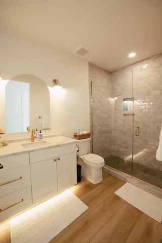 a view of hallway with wooden floor and stairs