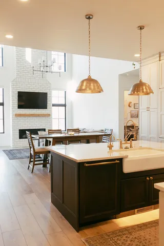 a kitchen with stainless steel appliances granite countertop a sink counter space and chairs