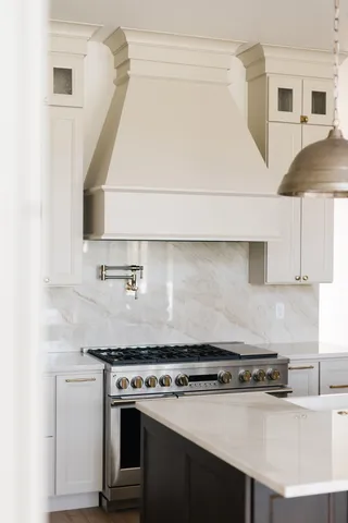 a stove top oven sitting inside of a kitchen