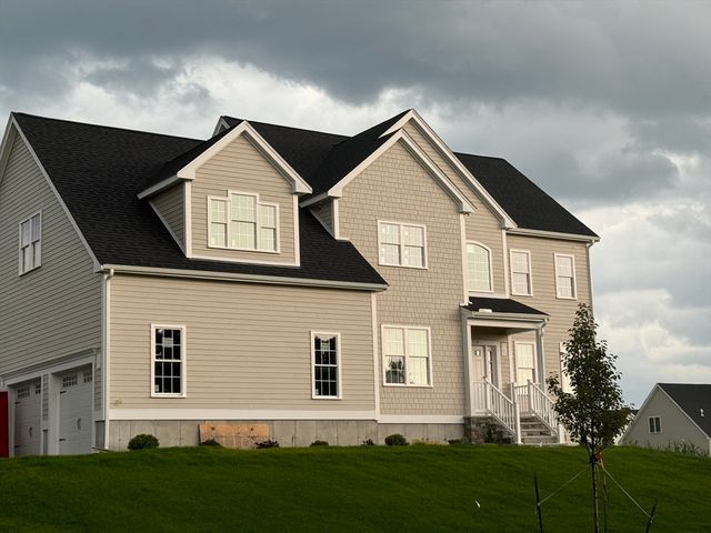 a front view of a house with a yard