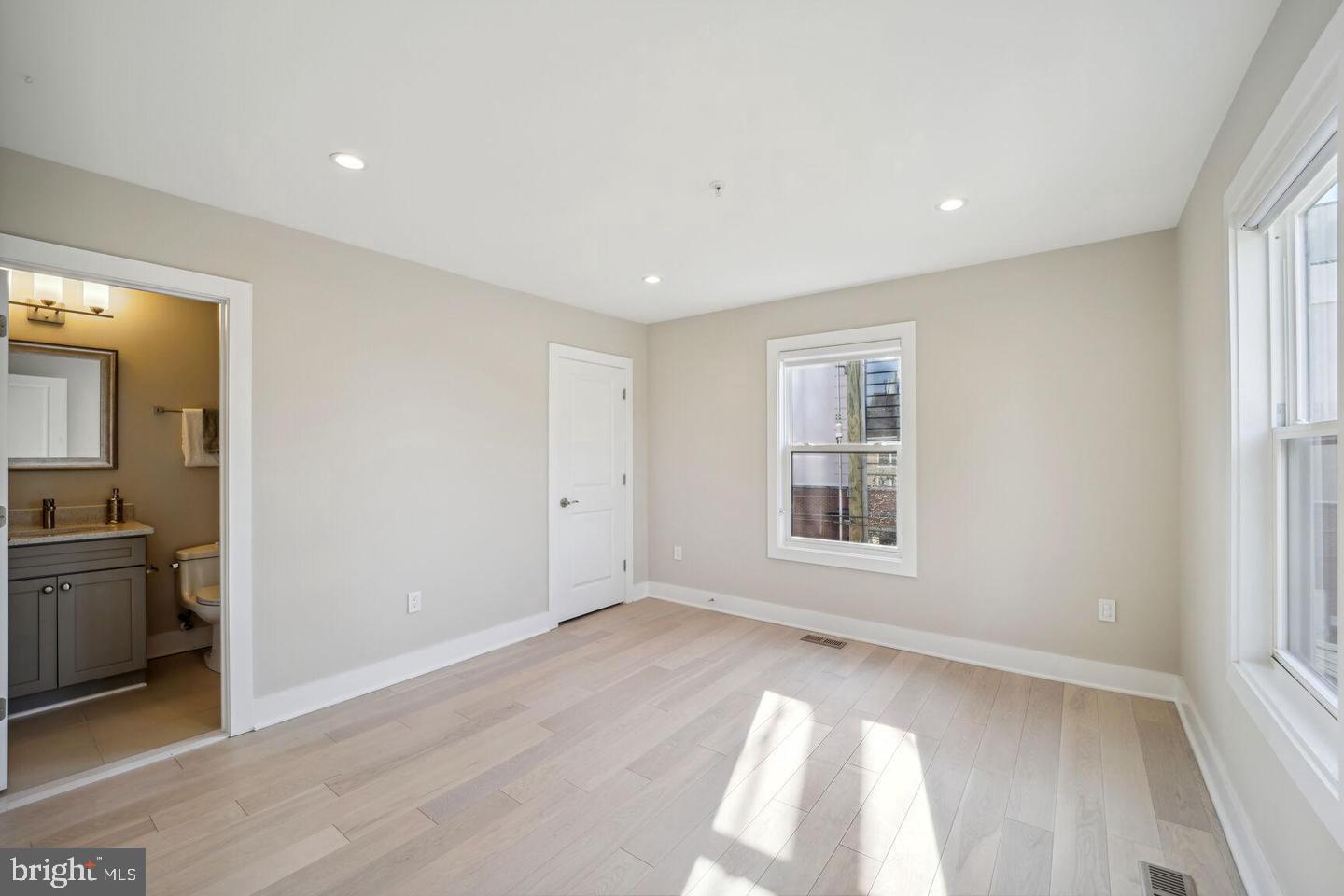 901 Lawrence Street Northeast Washington, DC 20017 - Photo 12 of 15 wooden floor in an empty room with a window