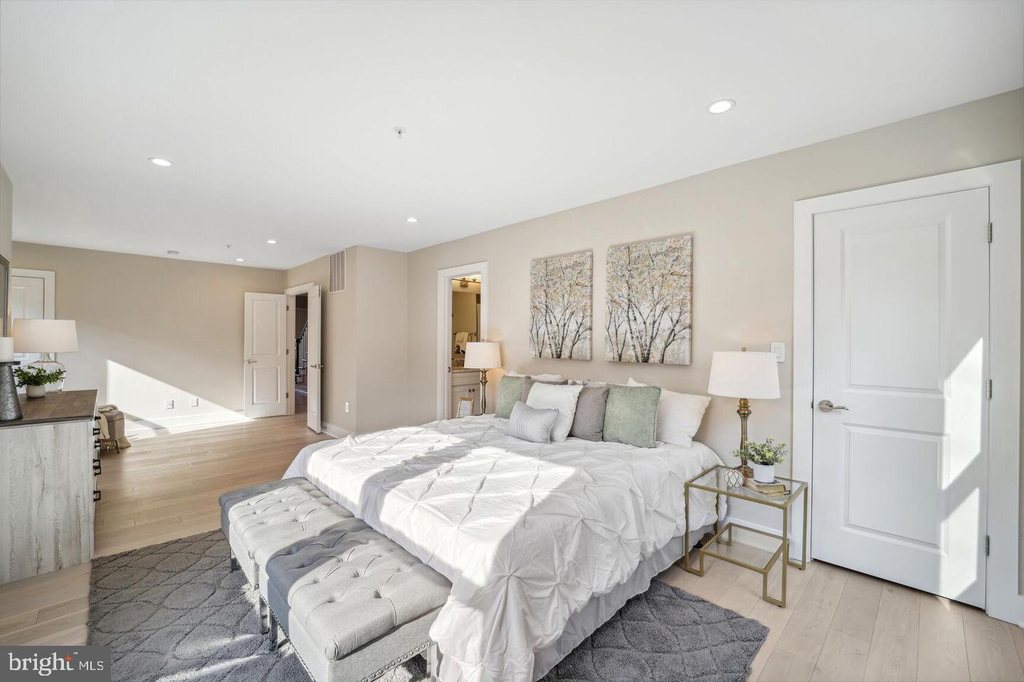 901 Lawrence Street Northeast Washington, DC 20017 - Photo 9 of 15 a spacious bedroom with a bed and a large mirror