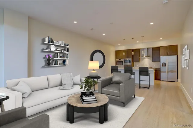 a living room with furniture kitchen view and a couch