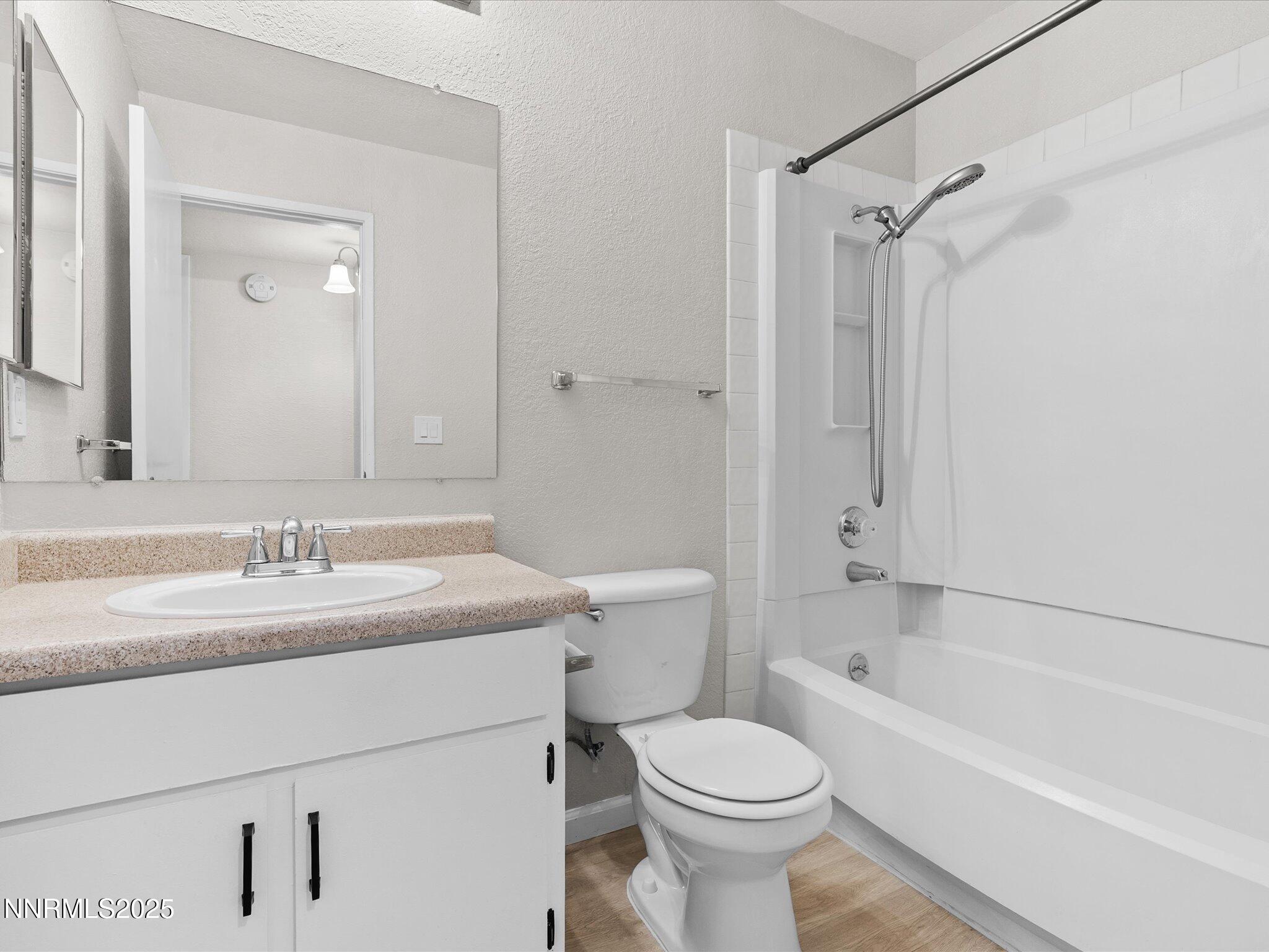 7680 Bluestone Drive, Unit 356 Reno, NV 89511 - Photo 20 of 23 a bathroom with a sink toilet vanity and shower