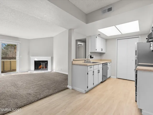 a kitchen with a sink appliances and cabinets