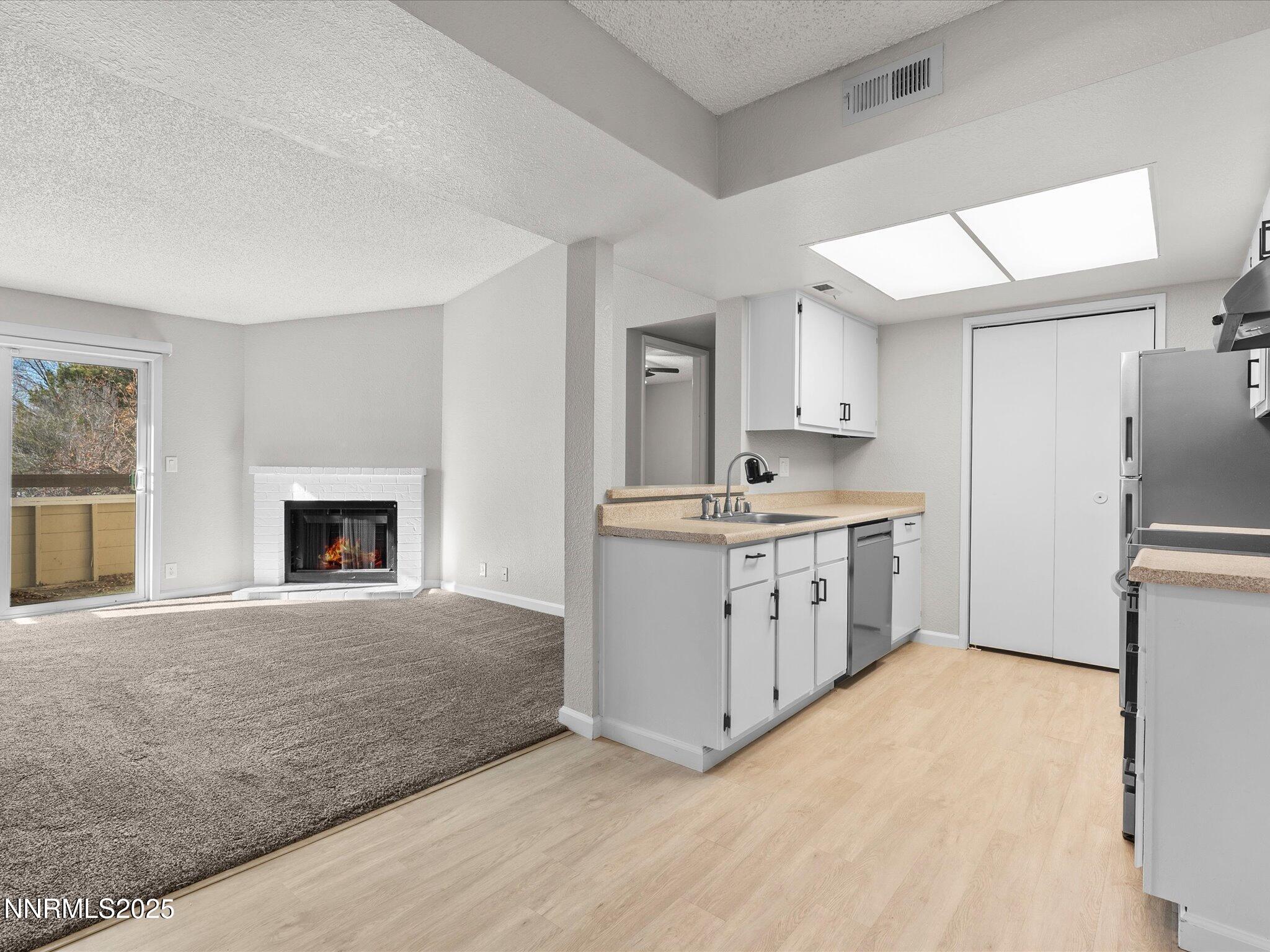 7680 Bluestone Drive, Unit 356 Reno, NV 89511 - Photo 7 of 23 a kitchen with a stove top oven and refrigerator