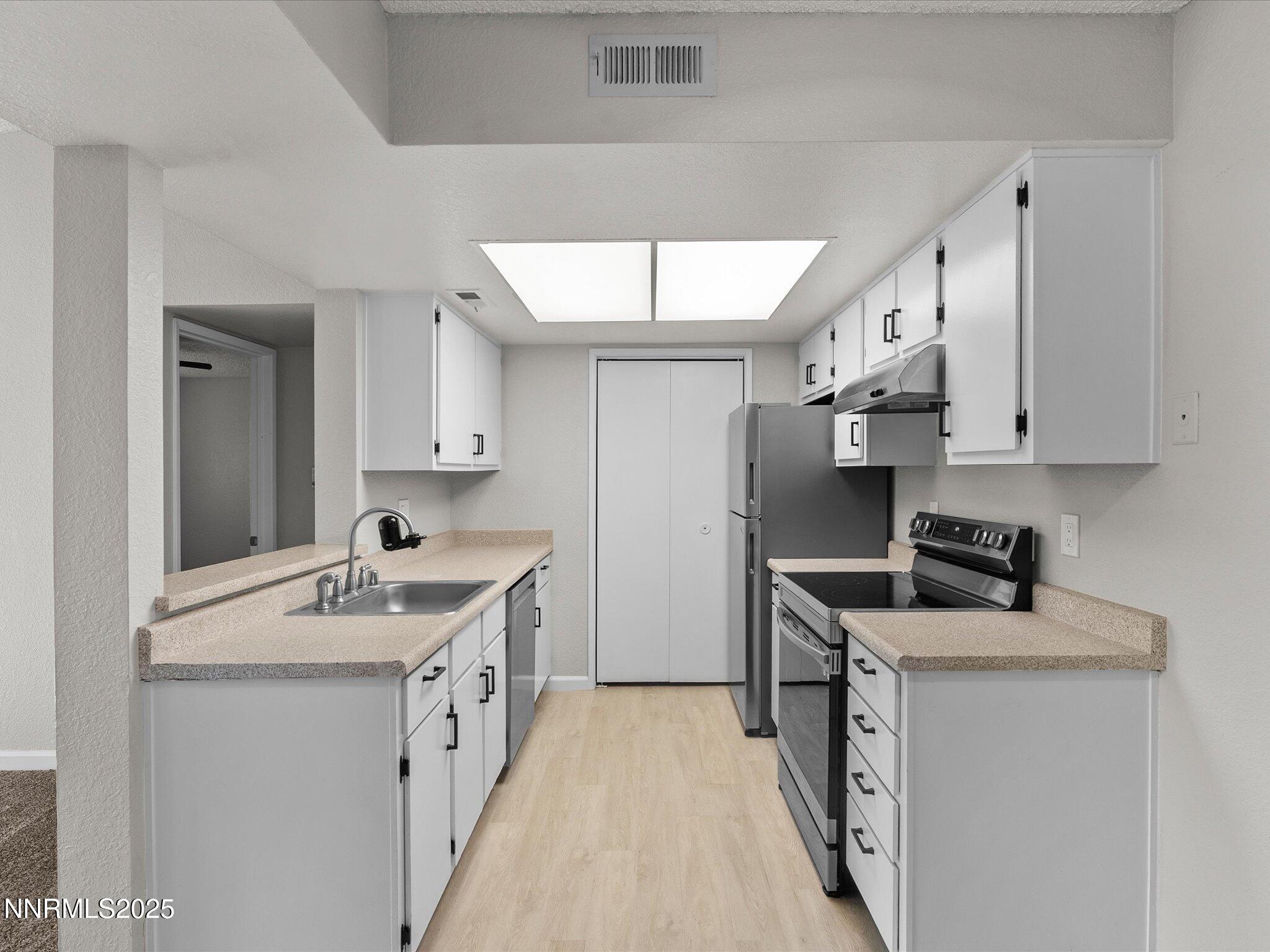 7680 Bluestone Drive, Unit 356 Reno, NV 89511 - Photo 8 of 23 a kitchen with stainless steel appliances granite countertop a sink stove and refrigerator