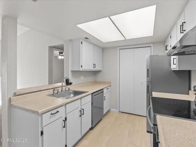 a kitchen with a sink stove and cabinets