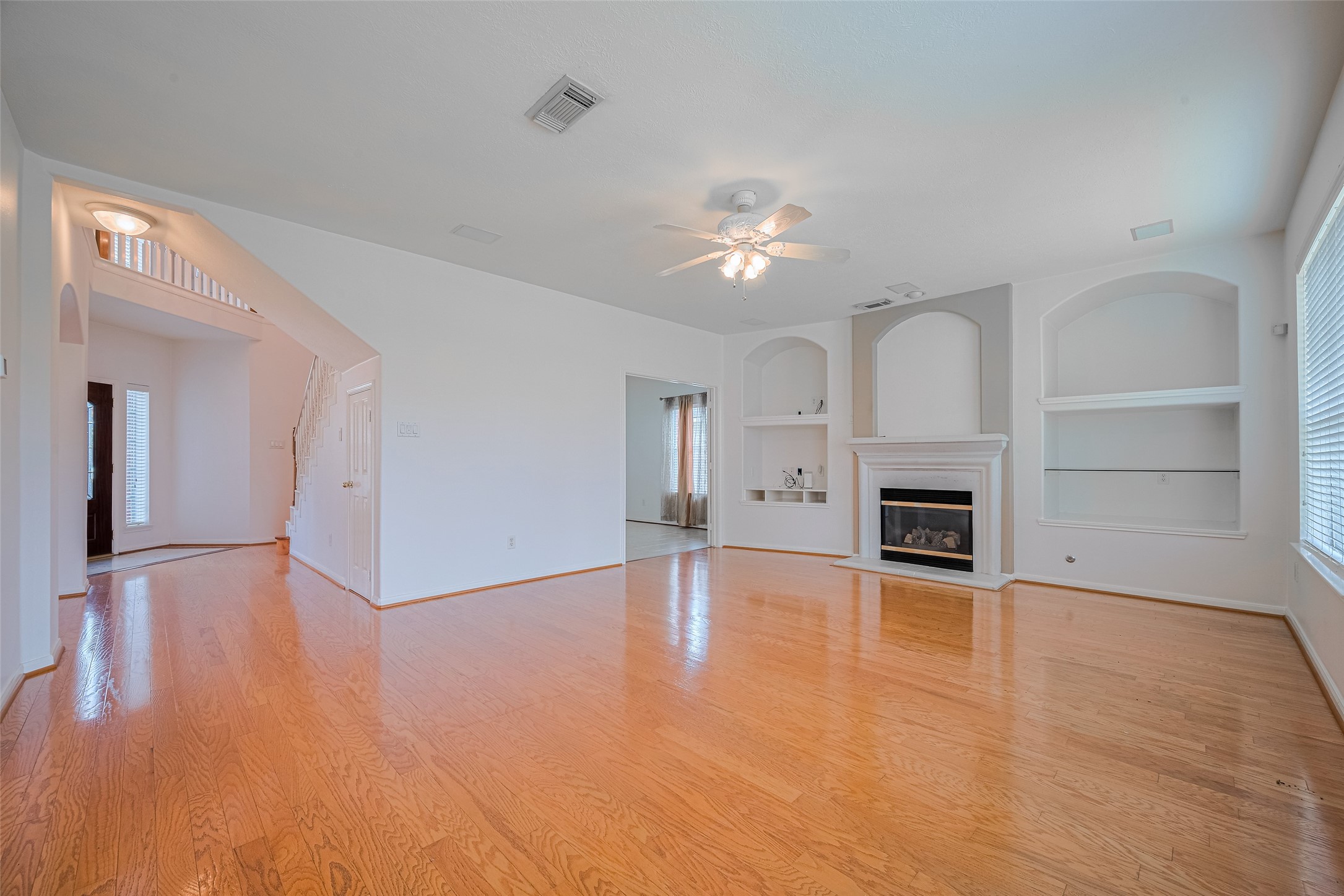 9218 Memorial Pines Way Spring, TX 77379 - Photo 12 of 39 Cozy family room with built-in shelving and a charming gas fireplace.