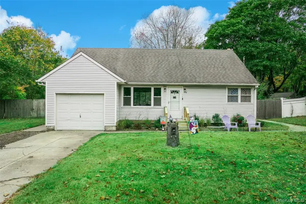 a front view of house with yard and green space