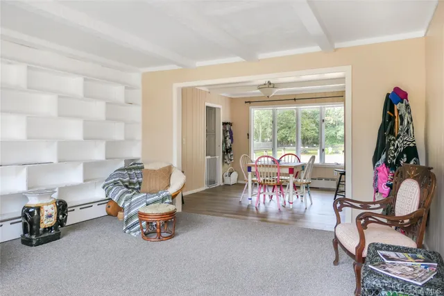 a living room with furniture and a floor to ceiling window