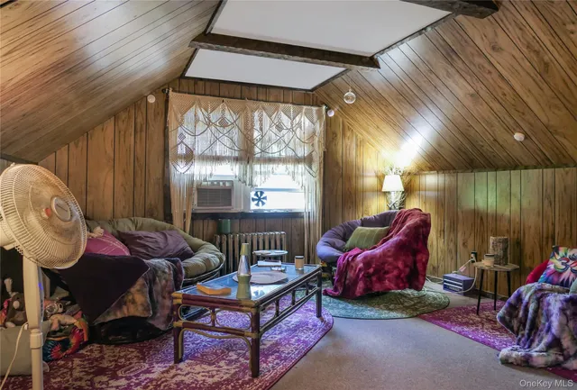a living room with furniture a window and a flat screen tv