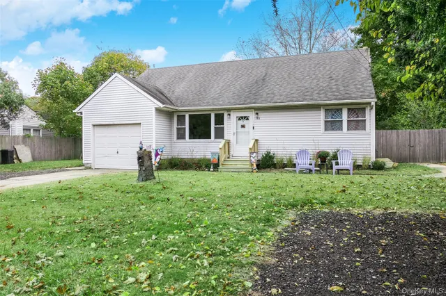 a backyard of a house with plants and barbeque oven
