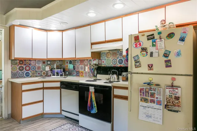 a kitchen with stainless steel appliances a sink a stove and a refrigerator