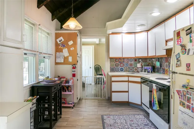 a kitchen with stainless steel appliances kitchen island granite countertop a stove a sink and a refrigerator