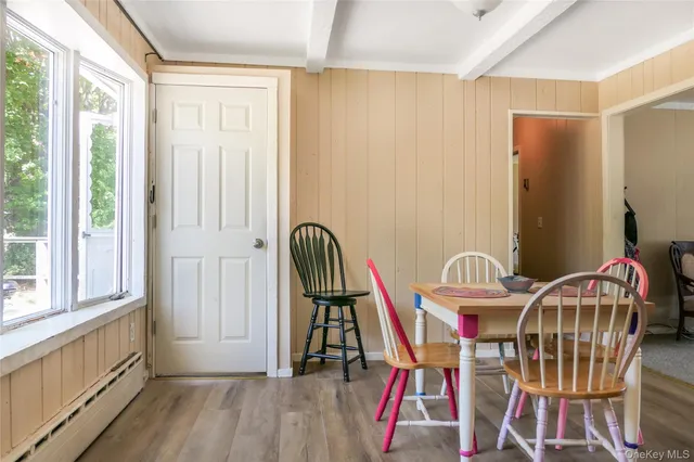 a view of a dining room with furniture window and wooden floor
