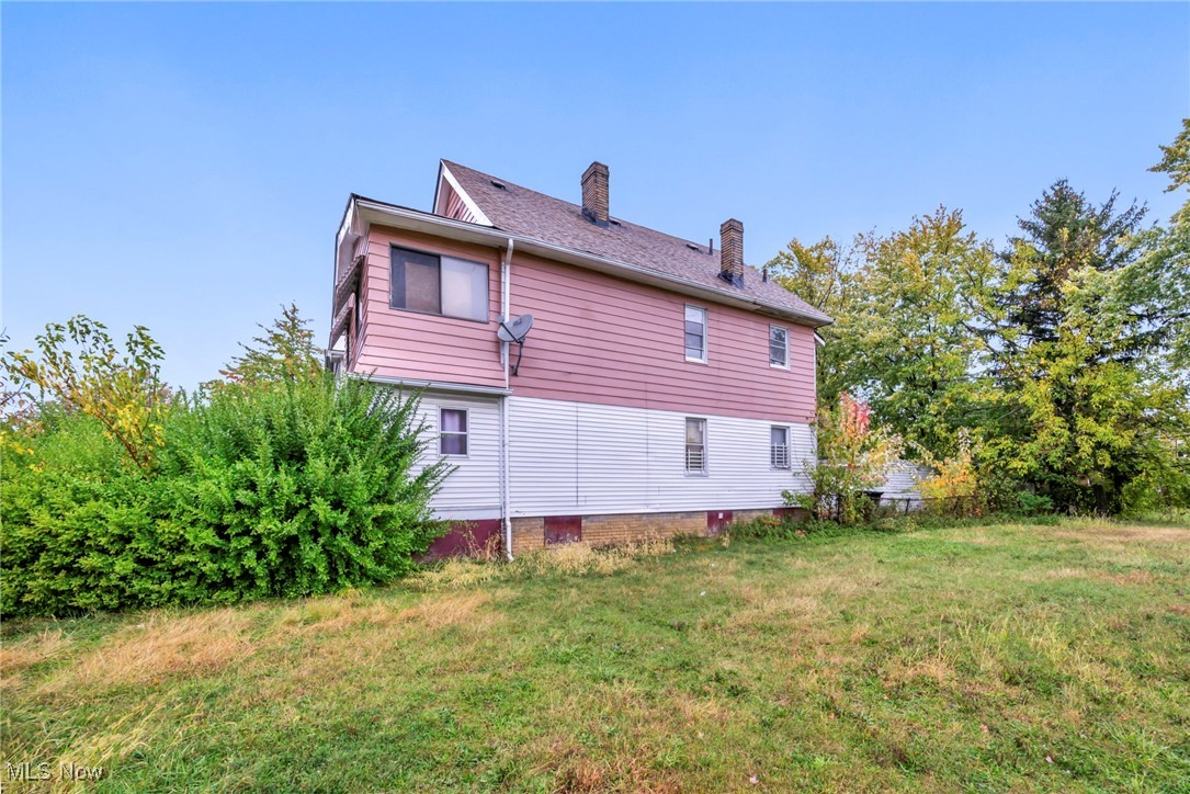 949 Rudyard Road Cleveland, OH 44110 - Photo 3 of 42 Back of house featuring a chimney and a lawn