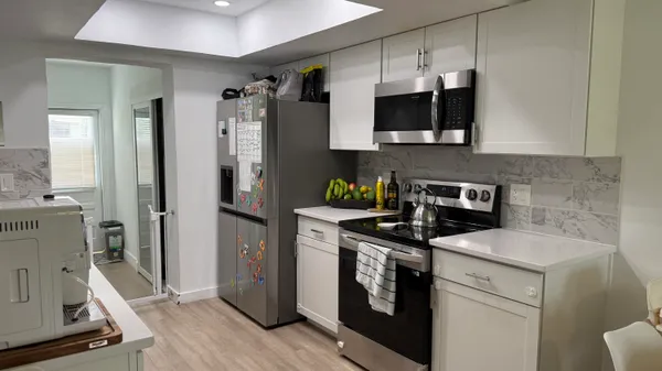 a kitchen with a stove and a refrigerator